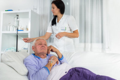woman monitoring dextrose of an elderly man