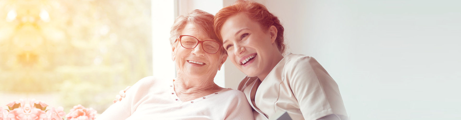 smiling elderly woman together with a middle aged woman